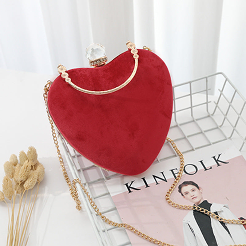 Heart-shaped hand holding chain bag