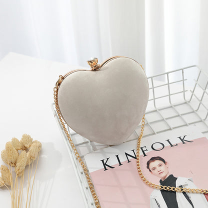 Heart-shaped hand holding chain bag