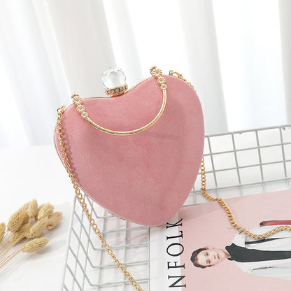 Heart-shaped hand holding chain bag