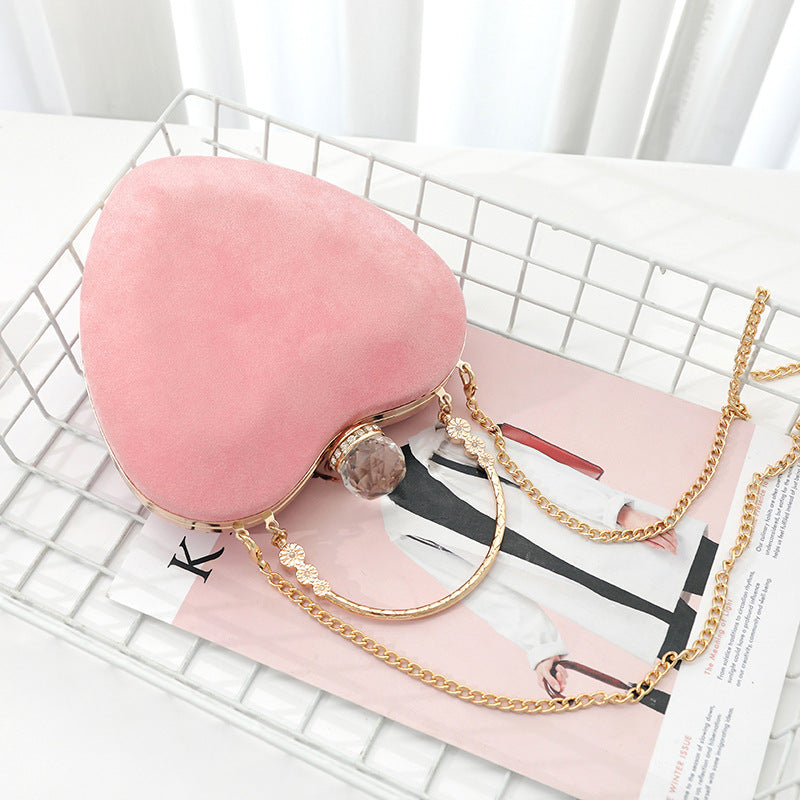 Heart-shaped hand holding chain bag