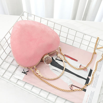 Heart-shaped hand holding chain bag